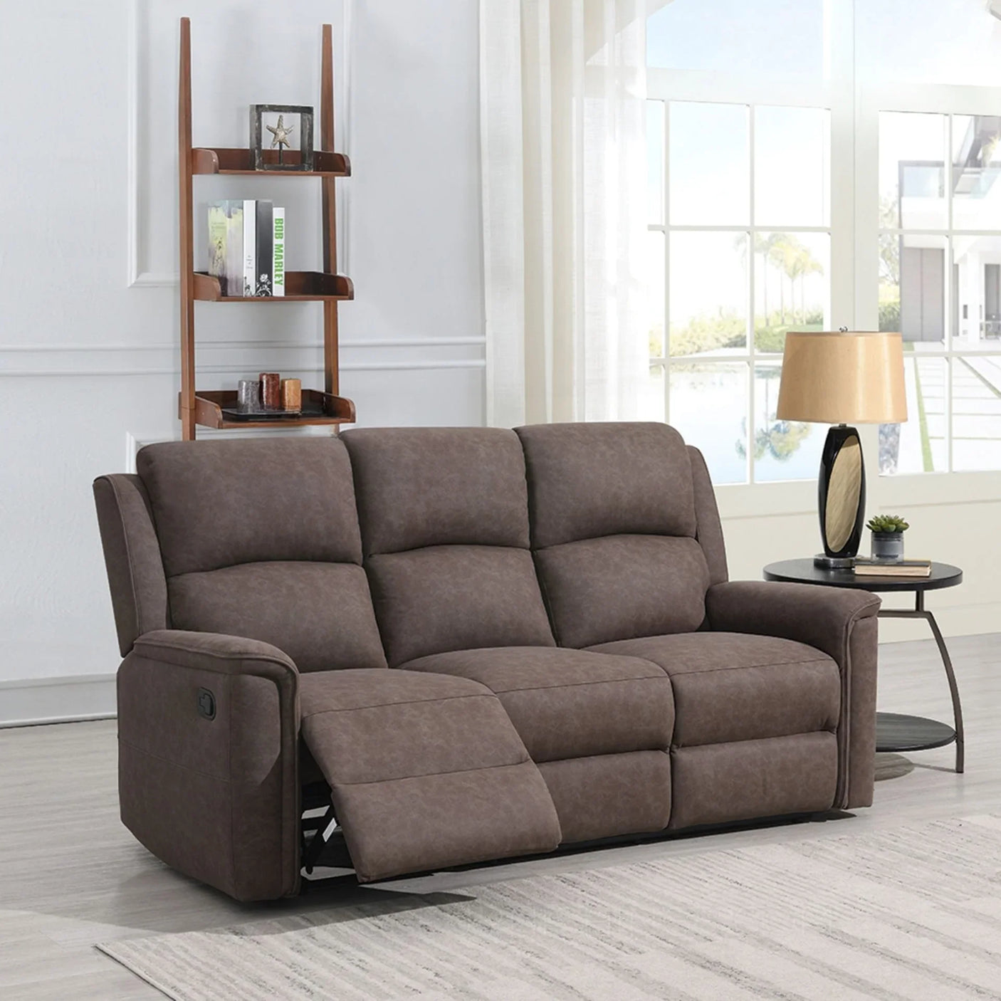 Brown fabric recliner sofa with padded seats and open footrest in a bright living room