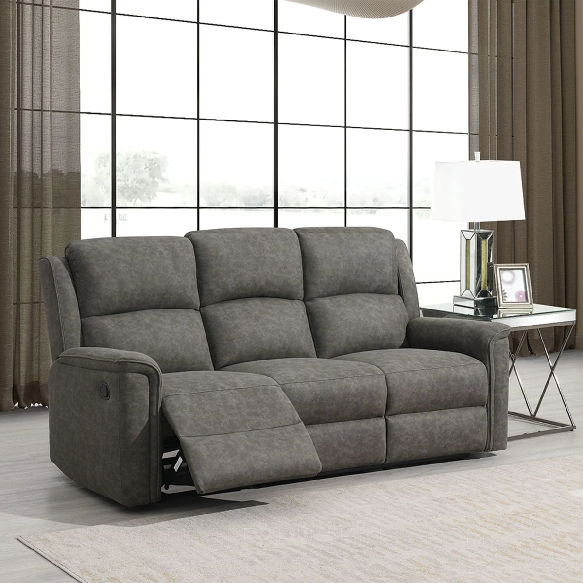 Grey fabric three seater recliner sofa in modern living room with large window
