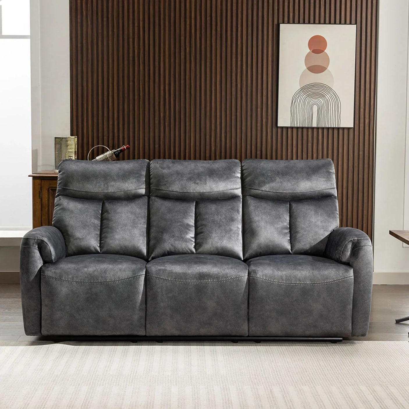 Dark grey fabric reclining sofa with padded seats in modern living room setting