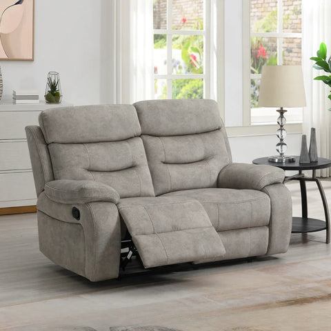 Cream 2 seater loveseat with matching piping and recliner positioned in a bright living room