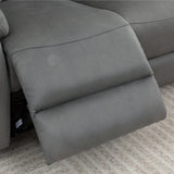 Charcoal grey recliner sofa footrest extended on patterned beige carpet