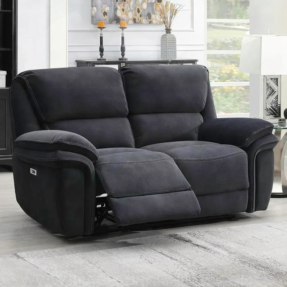 Dark grey fabric recliner sofa with extended footrest in a bright living room setting