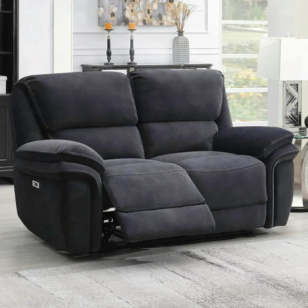 Dark grey fabric recliner sofa with extended footrest in a bright living room setting