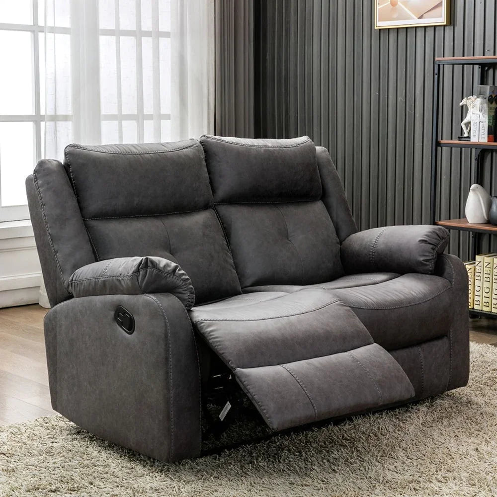 Dark grey 2 seater recliner sofa with plush cushions in modern living room setting
