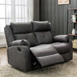 Dark grey 2 seater recliner sofa with plush cushions in modern living room setting