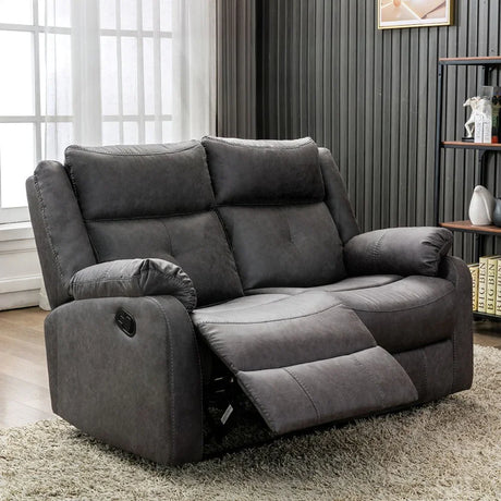 Dark grey 2 seater recliner sofa with plush cushions in modern living room setting