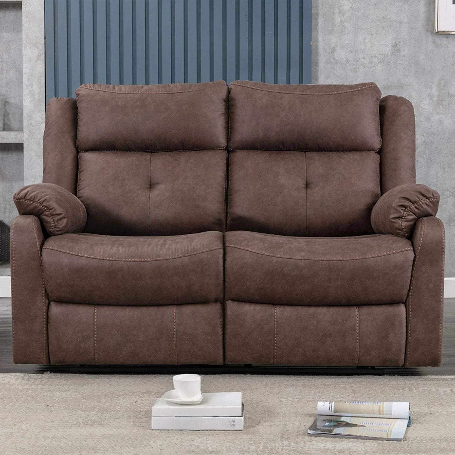 Brown two-seater sofa with plush cushions and armrests in a modern living room setting