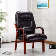 Orthopedic chair with burgundy faux leather seat and wooden arms in a modern living room