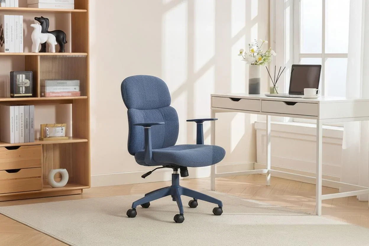 Blue office chair with armrests on castors in home workspace next to desk and bookshelf