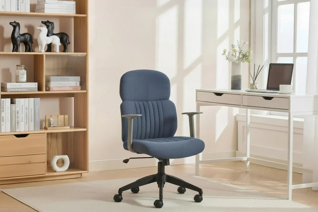 Blue office chair with wheels and armrests in home workspace beside white desk and bookshelf