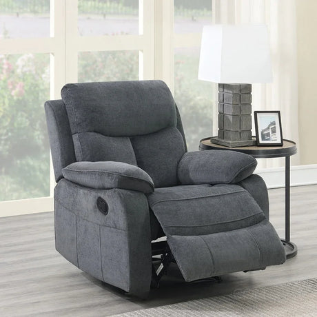 Grey fabric recliner armchair with extended footrest beside round side table and lamp