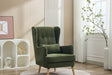 Moss green wing chair with cushion and wooden legs in a modern living room setting