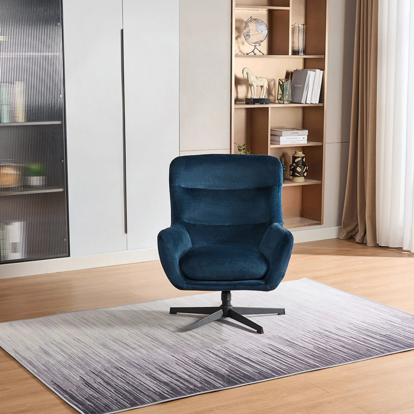 Deep ocean blue swivel recliner chair with metal base on a gradient rug in modern living room