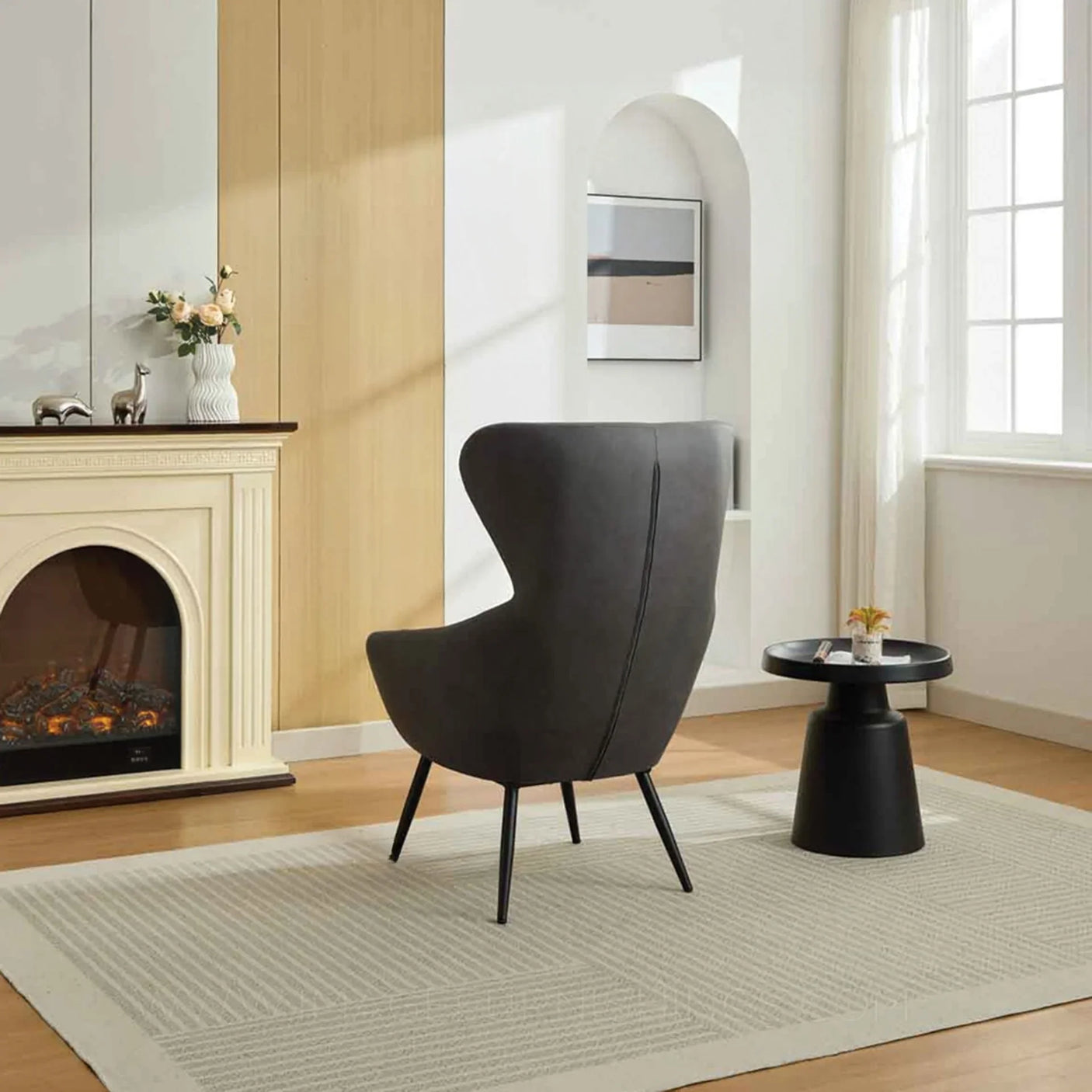 Graphite accent chair with curved back and black legs in modern living room next to side table