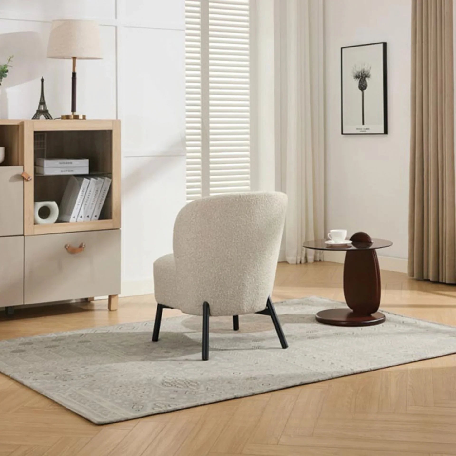 Natural beige accent chair with black legs on rug in modern living room