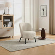 Natural beige accent chair with black legs on patterned rug in modern living room