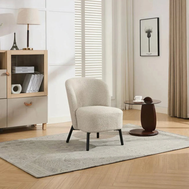 Natural beige accent chair with black legs on patterned rug in modern living room