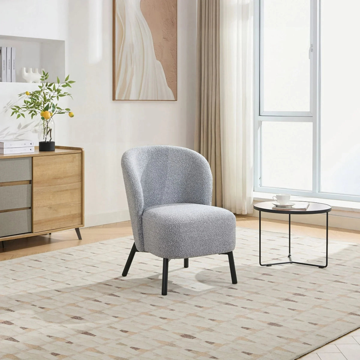 Talia accent chair in ash grey fabric with black legs in a modern living room setting