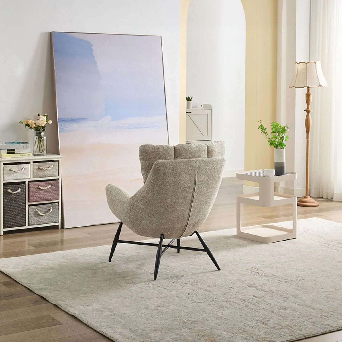 Beige accent chair with metal legs on light rug in modern living room