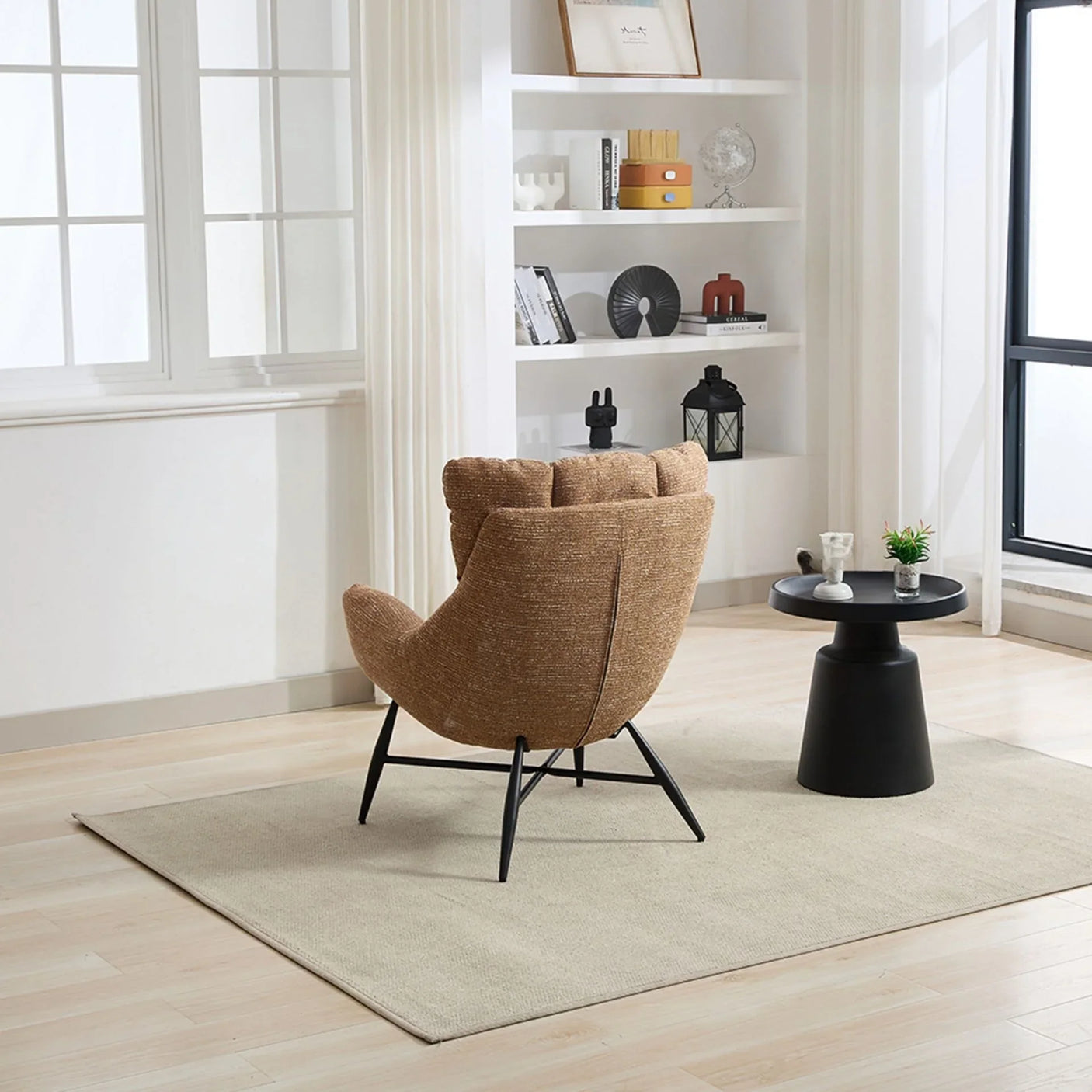 Rust accent chair with black legs on beige rug beside round black side table in modern living room