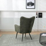 Green accent chair with fabric upholstery and black metal legs on patterned rug