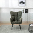 Green accent chair with tufted upholstery and black legs in modern living room setting
