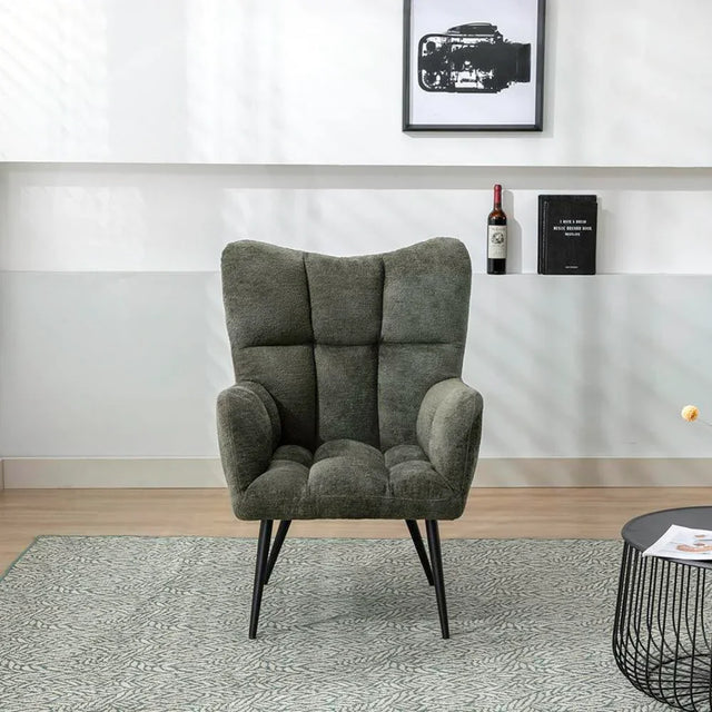 Green accent chair with tufted upholstery and black legs in modern living room setting