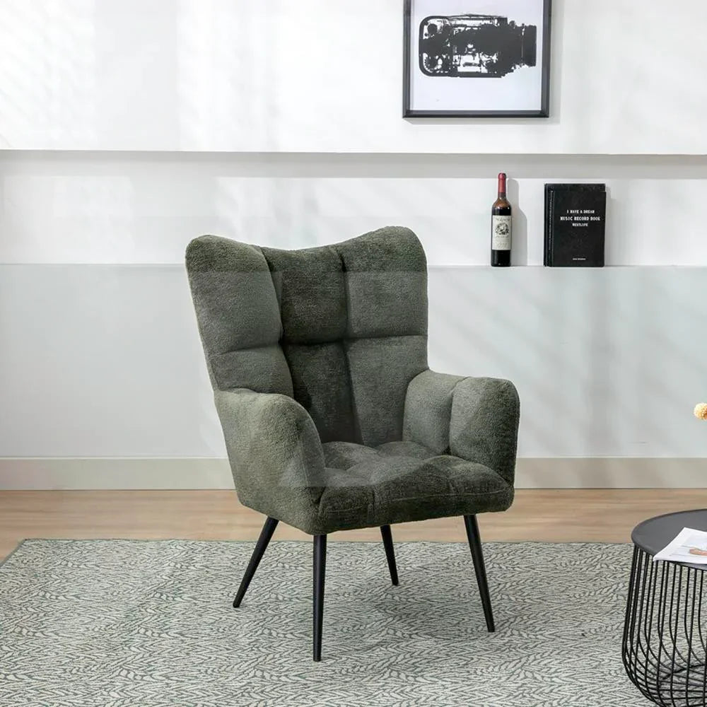 Green accent chair with black metal legs, textured upholstery, set on patterned rug in lounge