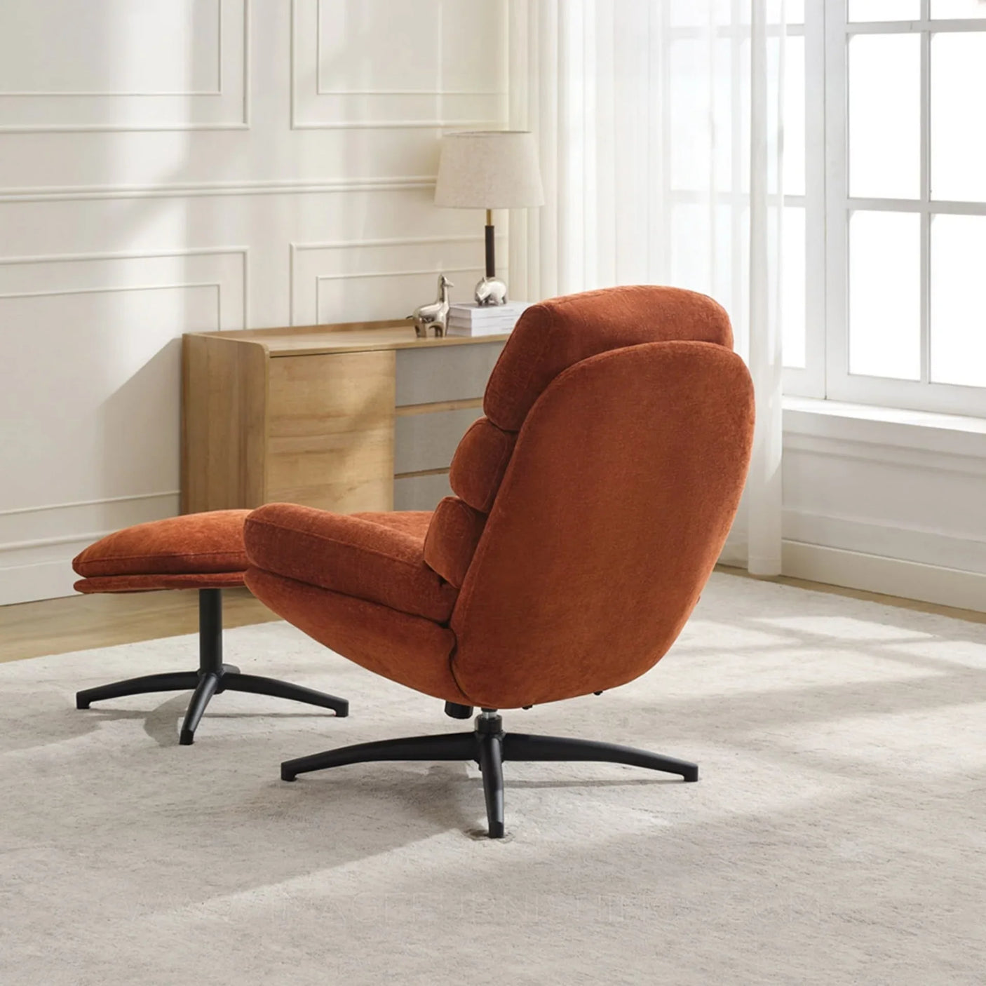Rust fabric leisure chair with footstool on black legs in modern living room setting