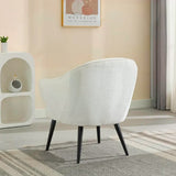 Cream accent chair with curved back and black legs on grey patterned rug