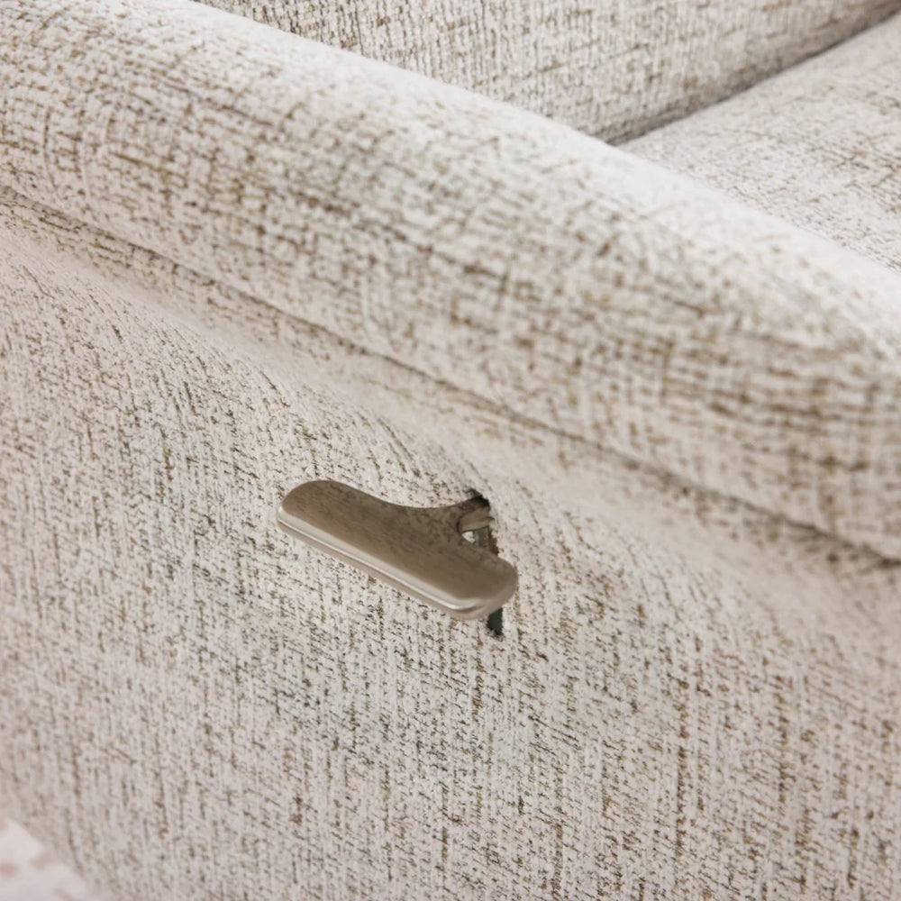 Beige swivel chair side lever detail on textured fabric armrest
