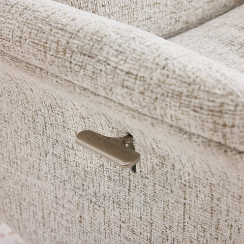 Beige swivel chair side lever detail on textured fabric armrest
