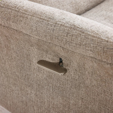 Close up of oatmeal fabric swivel chair with metal recliner lever