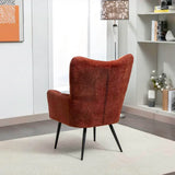 Rust accent chair with fabric upholstery and black legs in modern living room corner