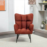 Rust accent chair with tufted upholstery and black legs in a modern living room