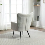 Light grey accent chair with black legs positioned on a striped rug near window
