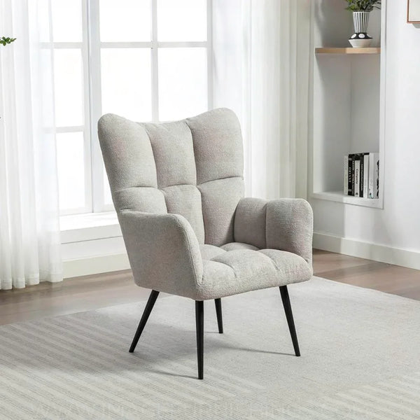 Light grey accent chair with tufted upholstery and black angled legs in modern living room