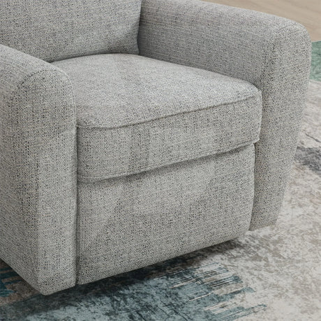 Close-up of grey fabric swivel chair with rounded arms on patterned rug