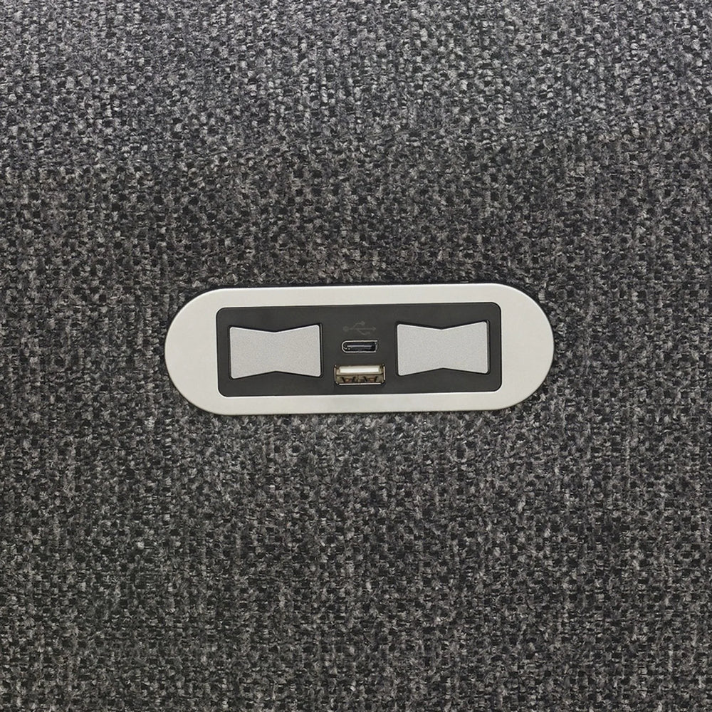 Close-up of USB charging ports set in dark grey fabric upholstery