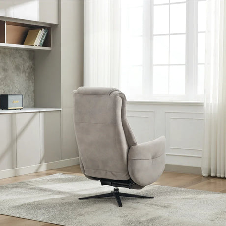 Oyster fabric swivel chair with black metal base on a rug in modern living room