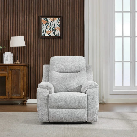 Light grey armchair with padded cushions in a modern living room with wood panel wall
