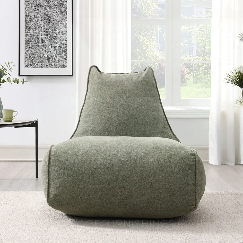 Pearl lounger bean bag in moss green fabric placed in a bright modern living room