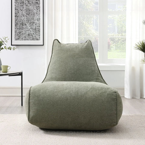 Pearl lounger bean bag in moss green fabric placed in a bright modern living room