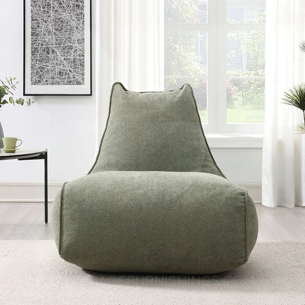 Pearl lounger bean bag in moss green fabric placed in a bright modern living room