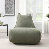 Pearl lounger bean bag in moss green fabric placed in a bright modern living room