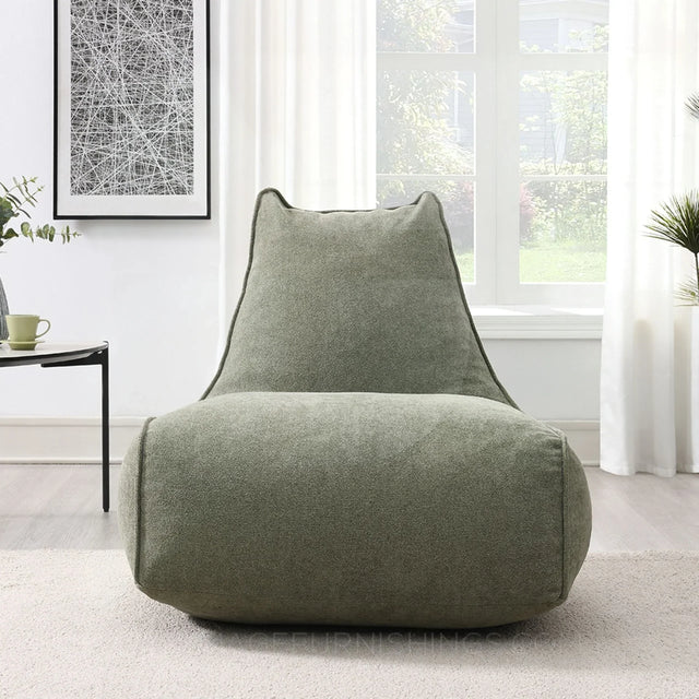 Pearl lounger bean bag in moss green fabric placed in a bright modern living room