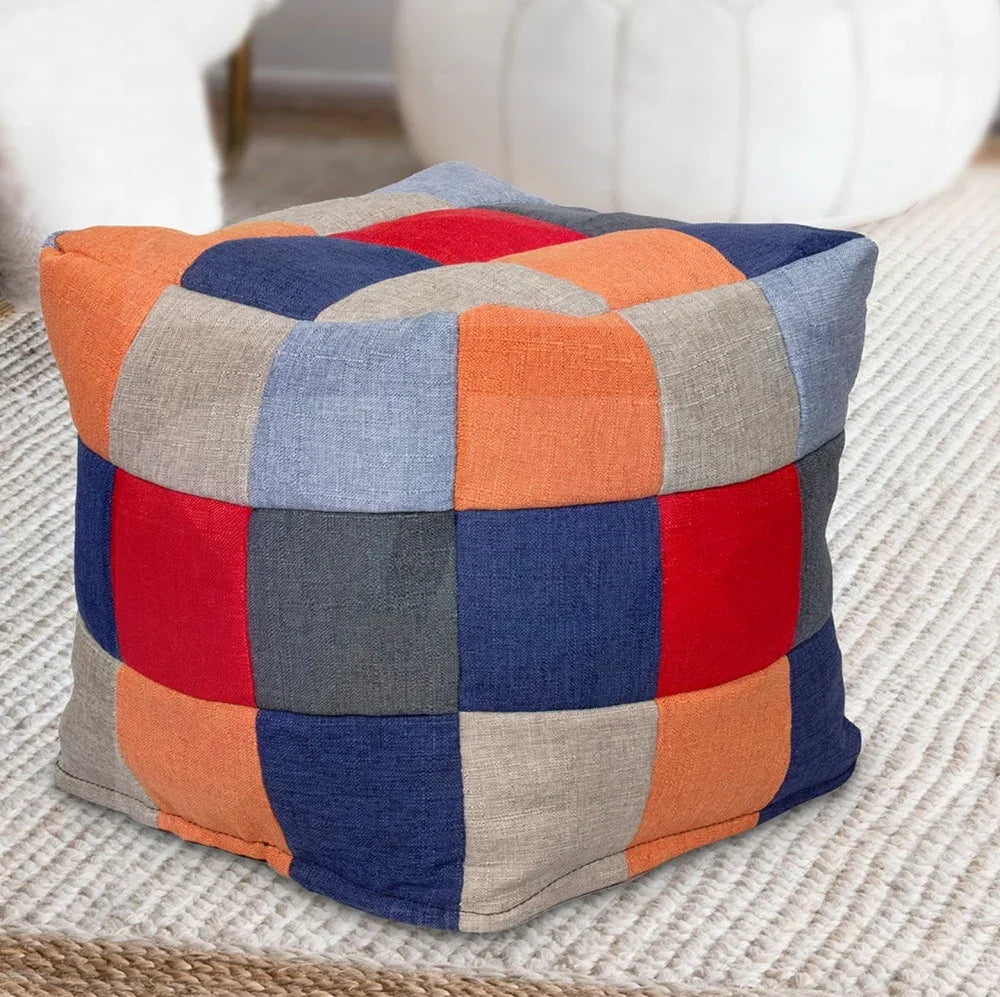 Patchwork fabric footstool with orange, blue, red, and beige squares on living room rug