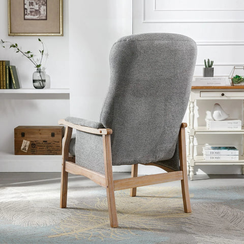 Grey fabric armchair with wooden frame shown from the back in a bright living room