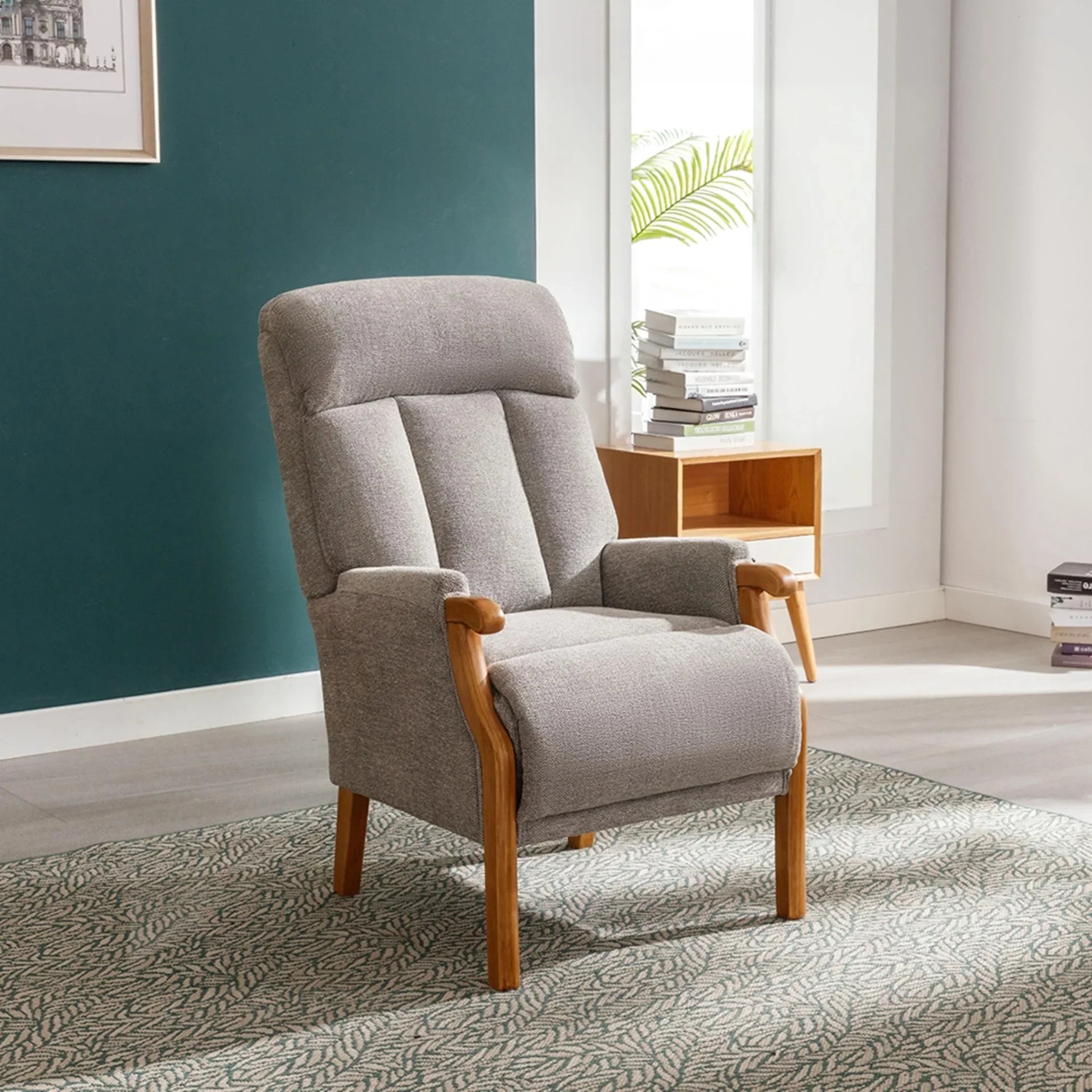 Silver fireside chair with wooden arms and legs on patterned rug in modern living room