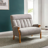 Silver fireside loveseat with wooden arms and legs on patterned rug in bright room